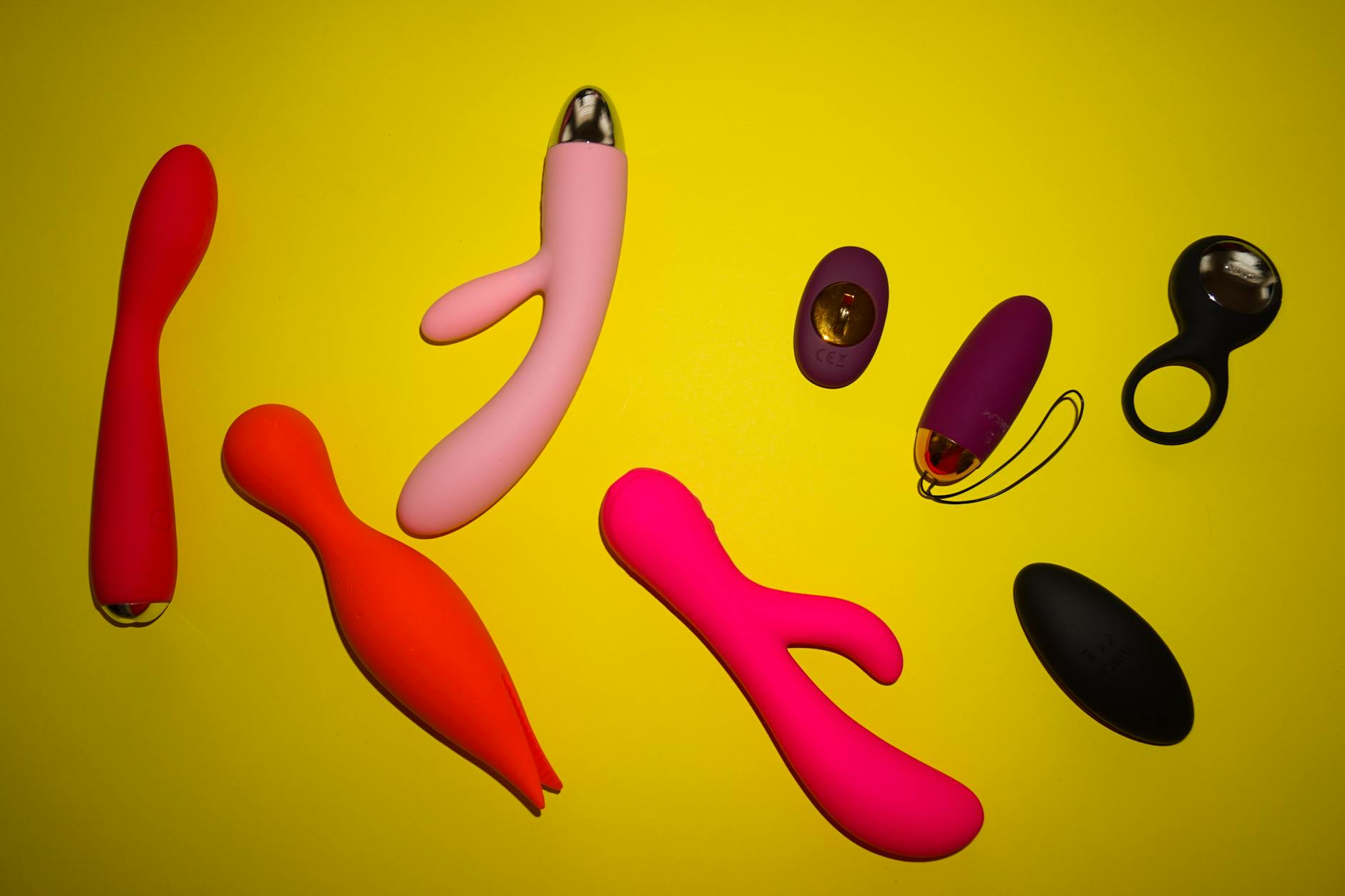 Colorful lemon vibrators and sex toys arranged on bright yellow surface showing modern design options