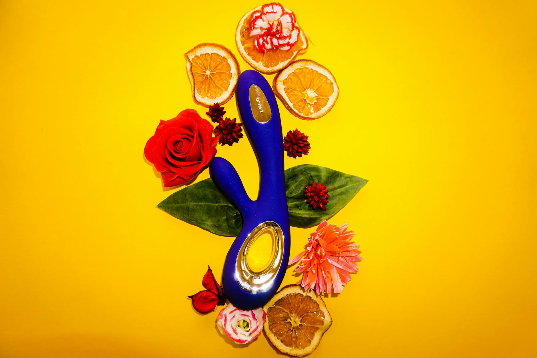 Close-up of hands holding a sleek blue vibrator against a soft background