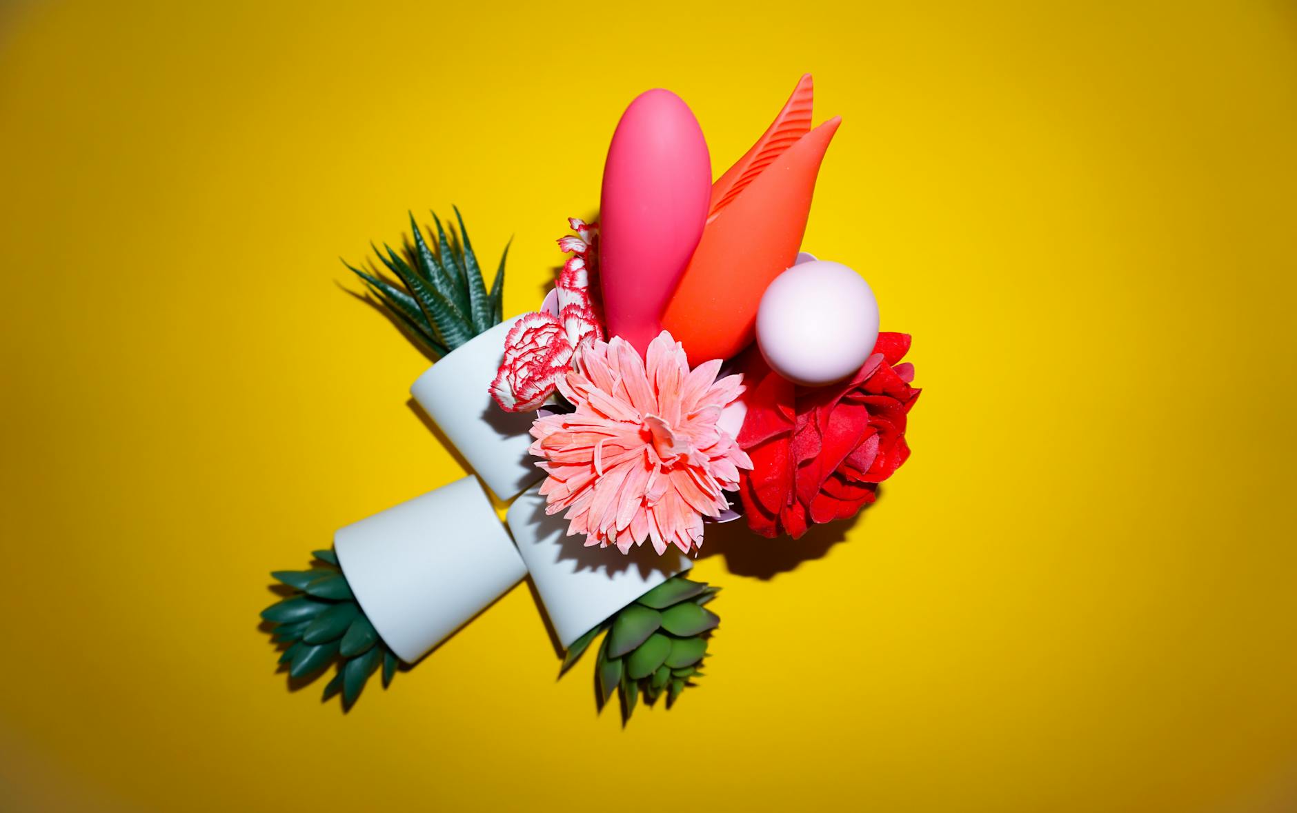 Woman holding colorful vibrators with confidence and intention